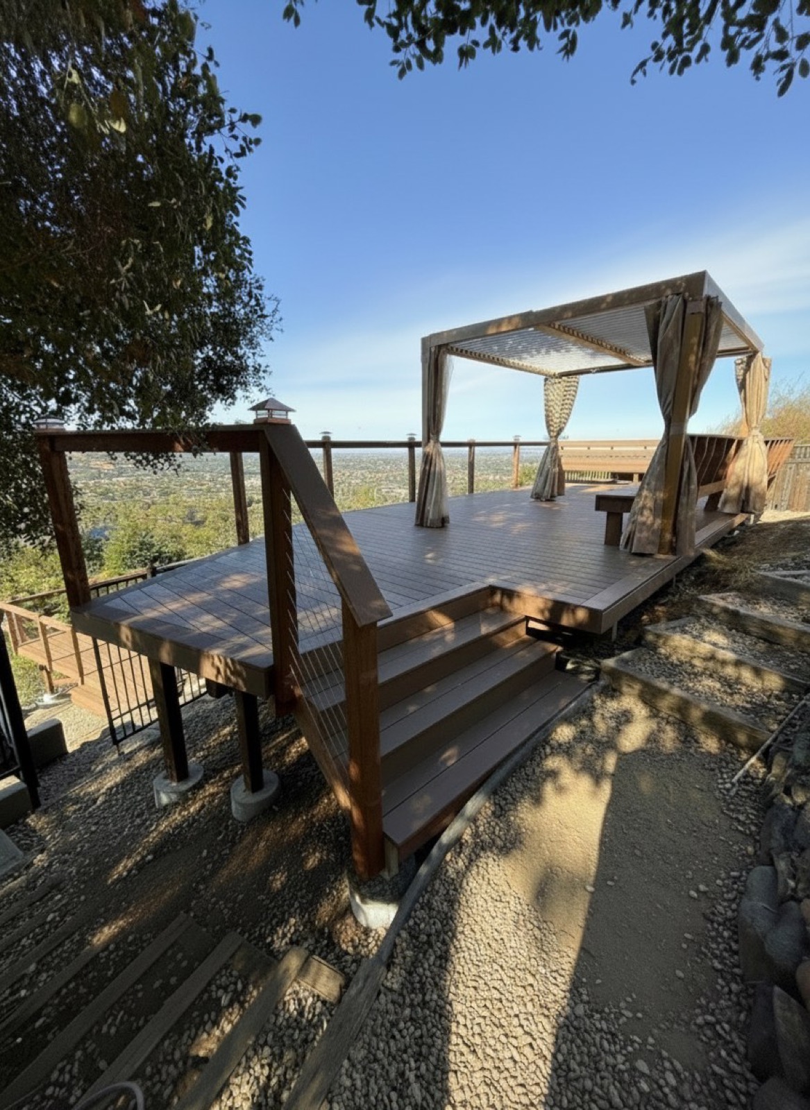 Hillside deck with louvered pergola cabana and valley view
